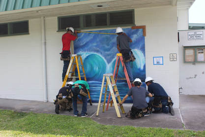 Picture: Workers installing mural in front of pool