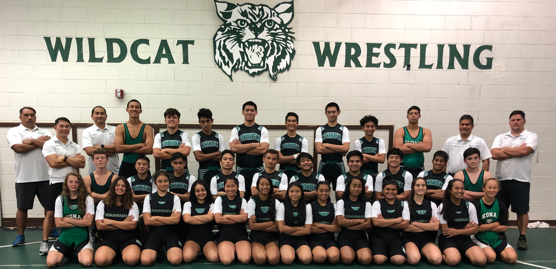 group Picture of wrestling team in uniform with coaches
